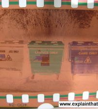 A 35mm film negative of recycling dumpsters.
