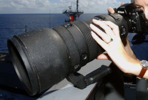 A camera with a large 400mm telephoto lens screwed on the front.