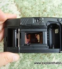 Inside the open back of a film camera.