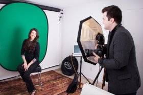 model posing on green collapsible backdrop