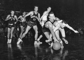 The first time North Carolina coach Dean Smith appeared in the NCAA Final Four, it was as player and member of the 1952 Kansas University team that won the National Championship that year. Here, Smith chases a loose ball in the semi-final game with Santa Clara won by Kansas 74-55. Rich Clarkson